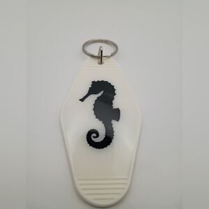 White Keychain with Black Seahorse Design
